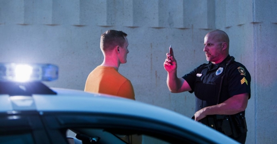policeman performing sobriety test on driver