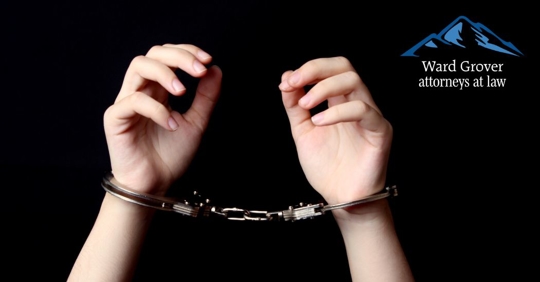 closeup of teenager's hands with handcuffs